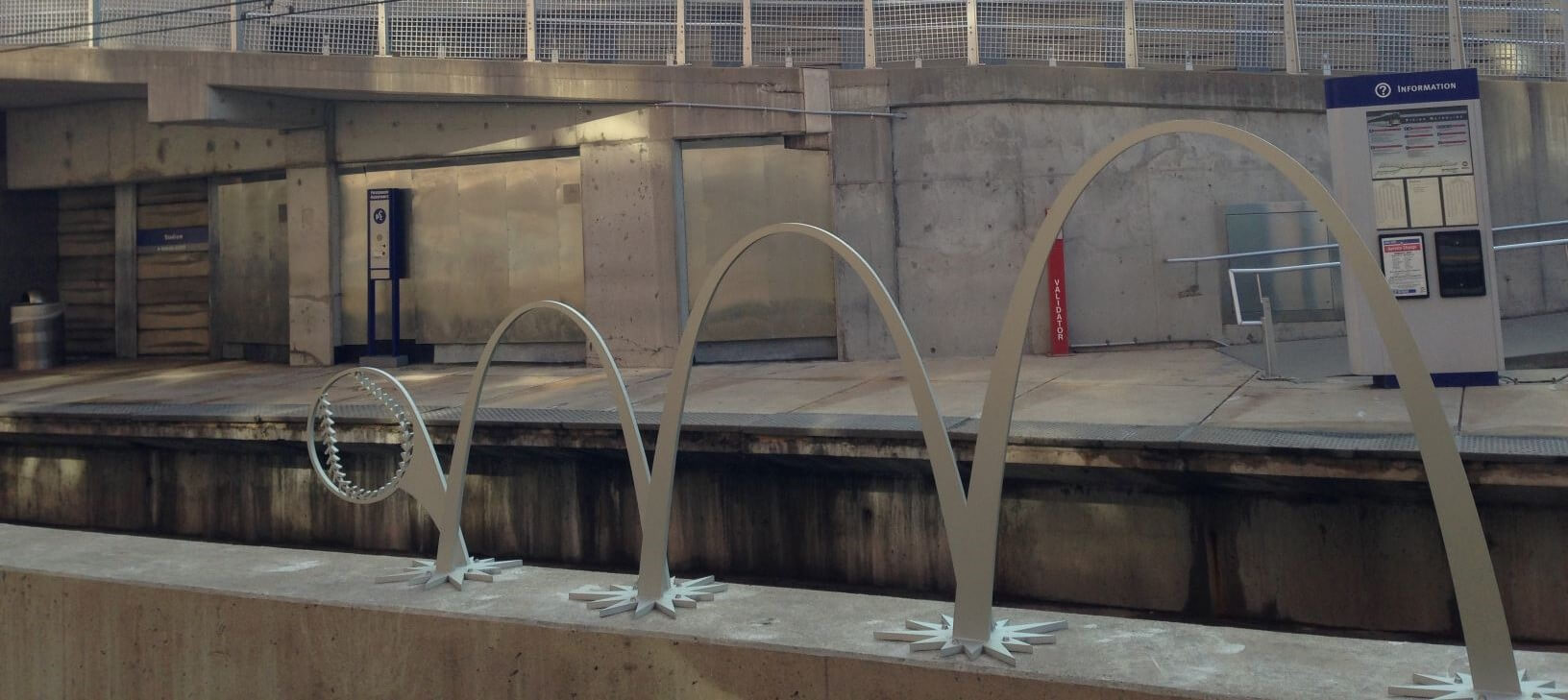 Out of the Park is an aluminum public art sculpture by Andrews/LeFevre Studios located at Stadium MetroLink Station. The sculpture depicts a baseball bouncing in an arc that resembles the Gateway Arch.