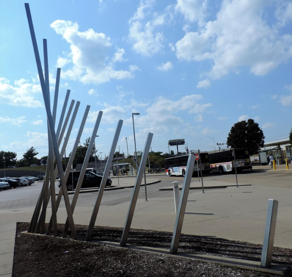 A Line Meant (Circular)... Alignment (Reasoning) is a public art sculpture installed at the North Hanley MetorLink Station that was created by artists Bob Hansman and Ben Hoffmann. The stainless steel artwork has inside and outside components that interact with each other as well as the existing architecture.