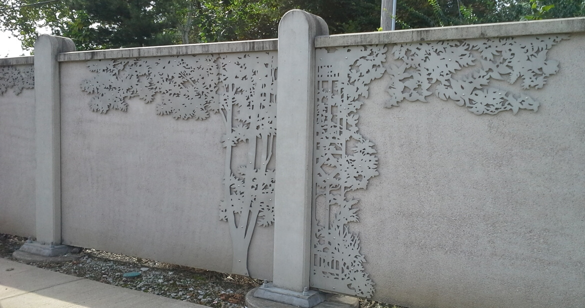 A Walk in the Park is a public artwork created by Andy Cross, Carl Harris, and Ty de LaVenta that is mounted to sections of a soundwall that runs along the MetroLink right-of-way between the Skinker and Forest Park-DeBaliviere stations. The panels are made from waterjet-cut aluminum and depict the silhouettes of trees, vines, and trellises.