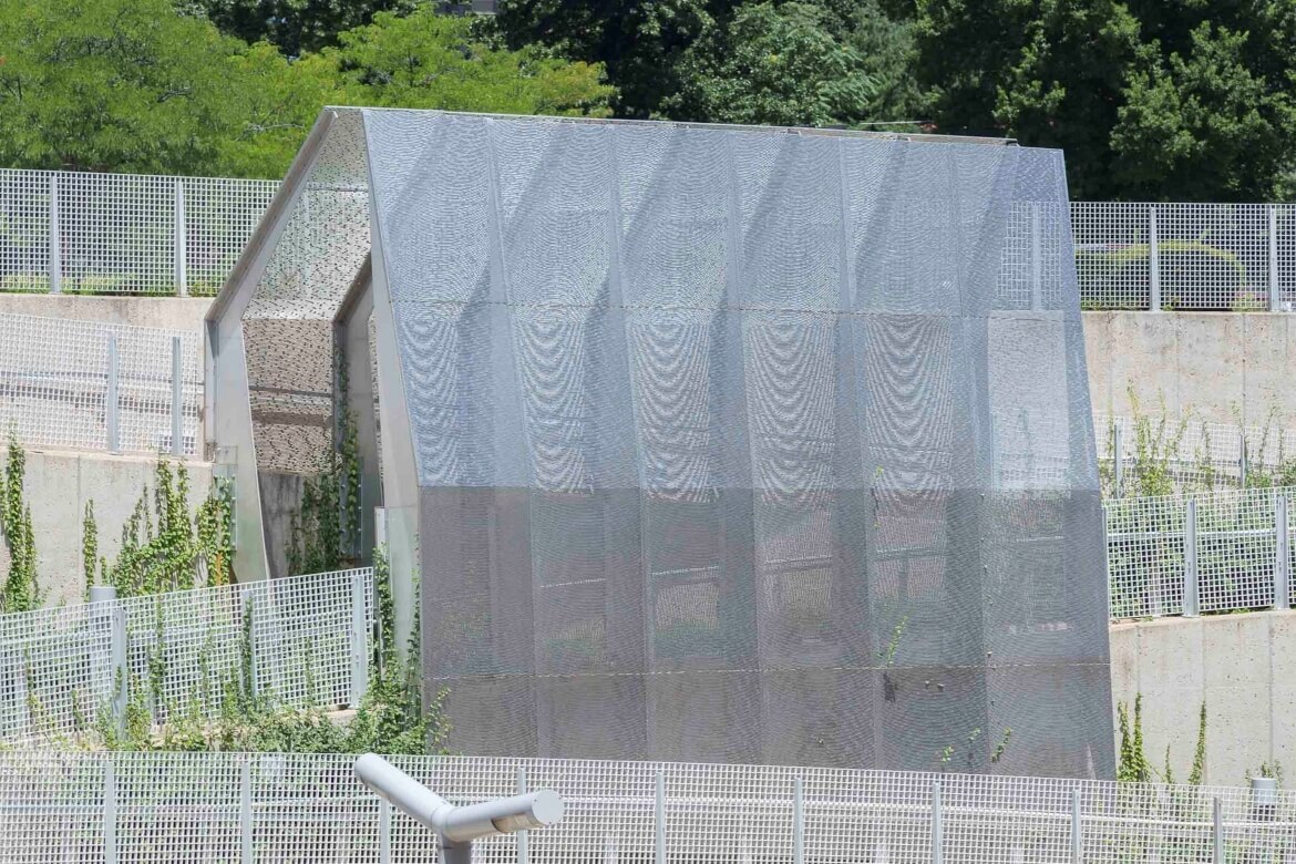 Hoi Polloi is a public art installation created by Lindsey Stouffer at the Forsyth MetroLink Station. Perforated, stainless steel screens appear to shimmer as people walk by.