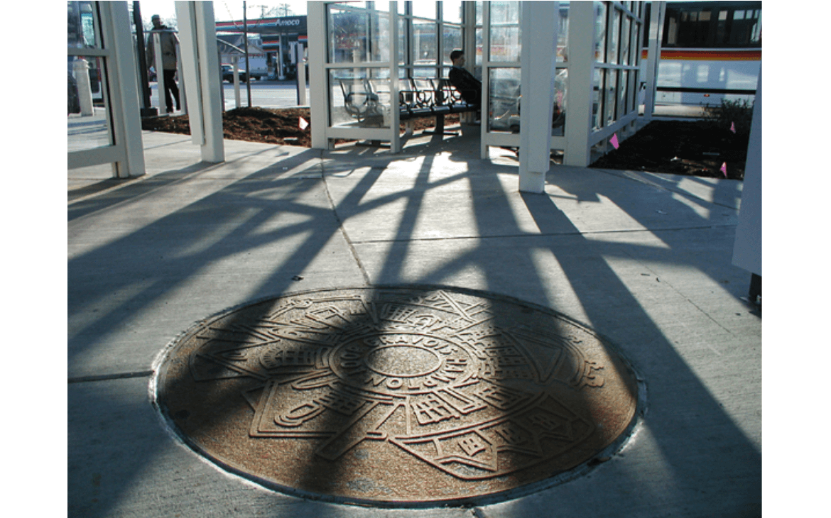 Medallion is a circular, cast-iron medallion embedded in the plaza of the Hampton-Gravois Transit Center and was created by artist Phil Robinson. Medallion reference local architectural motifs specific to South St. Louis.